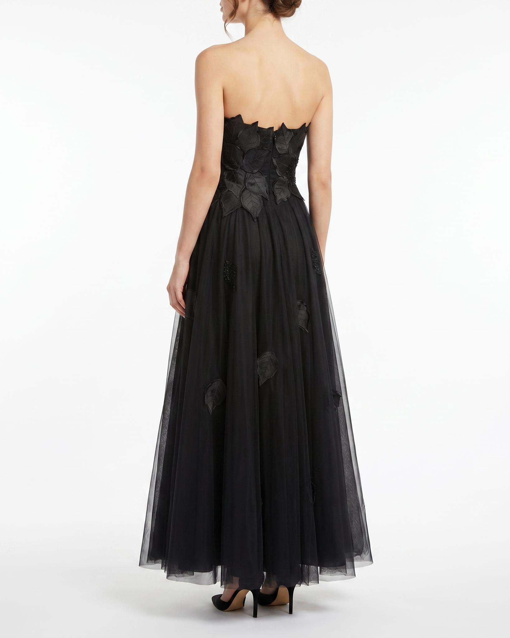 Black strapless gown with floral details on a white background